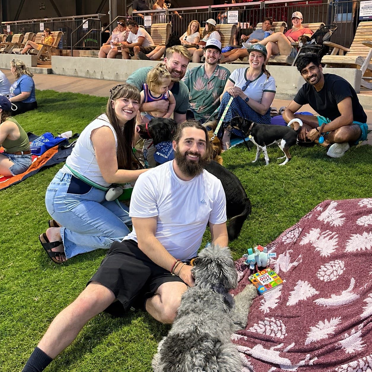 New Direction Dog Training members and their dogs together at an outdoor community event